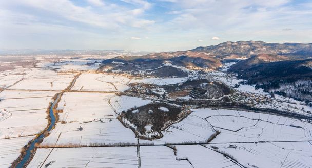 Aerial view of a river flowing through winter countryside. - Photo, Image