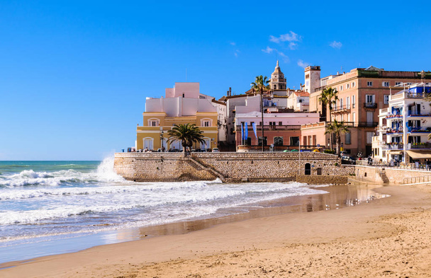 Beach on a background of not a calm sea and the old town - Photo, Image