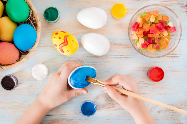 Velikonoční řemesla malý chlapec ruce maloval modrou velikonoční vajíčko - praparetion na Velikonoce - Fotografie, Obrázek