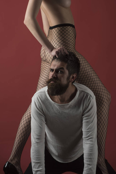 Dependence and henpecked concept. Female buttocksin fishnet tights - Foto, afbeelding