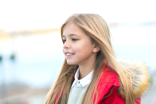 Child smile on blurred environment. Girl with blond long hair on autumn day outdoor. Happy childhood concept. Kid fashion and style. Beauty, look, hairstyle. - Zdjęcie, obraz
