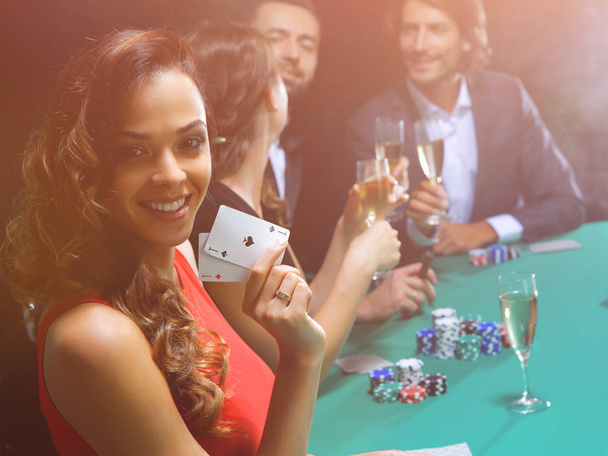 adult group celebrating friend winning blackjack - Photo, Image