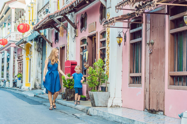 Mother and son walking on Street in Portugese style Romani in Phuket Town. Also called Chinatown or old town. Traveling with children concept - Φωτογραφία, εικόνα