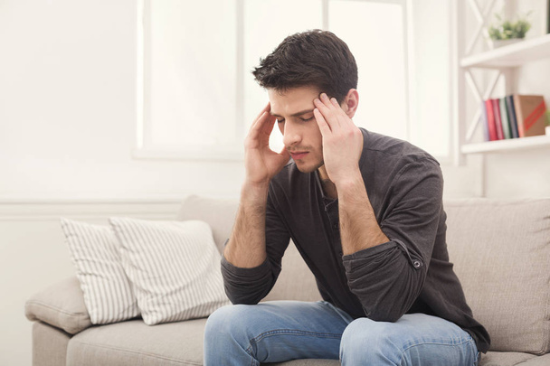Young man having headache at home - Фото, зображення