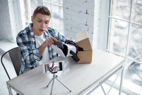 Determined blogger making a video about 3D model - 写真・画像