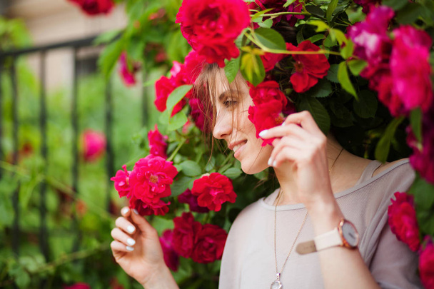 Beautiful tender woman in rose garden - Фото, изображение