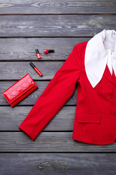 Top view red blazer sleeve and accessories. - Photo, Image