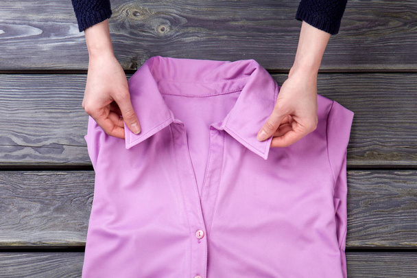 Woman hands and pink shirt collar. - Photo, Image