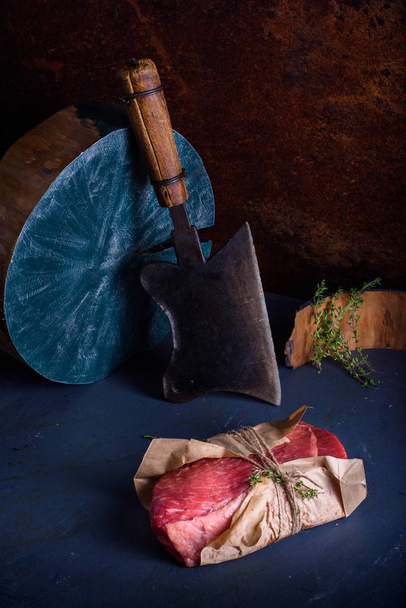 Raw beef steaks, with herbs, on wooden table. Concept of food cooking. - Foto, Bild