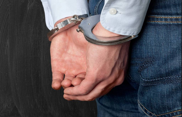 Man in handcuffs behind his back - Photo, Image