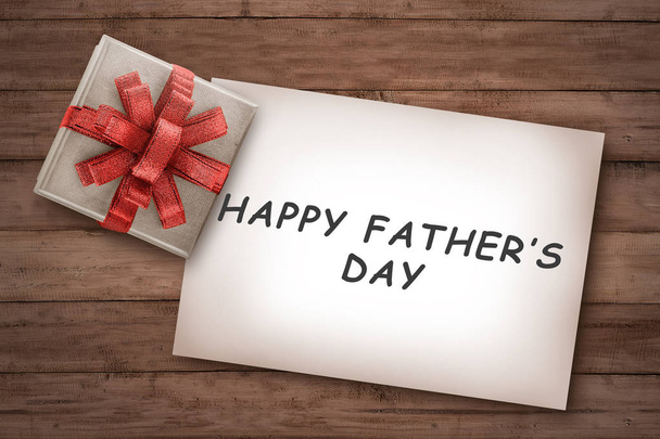 Happy fathers day messages on paper with gift on wooden background - Фото, изображение