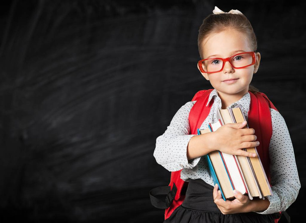 Little schoolgirl with books - Fotó, kép