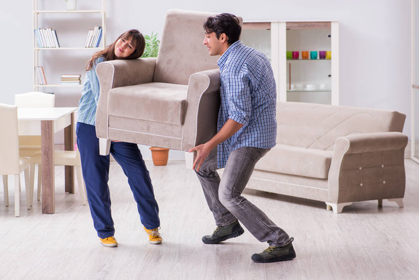Man moving armchair in the living room - Photo, Image