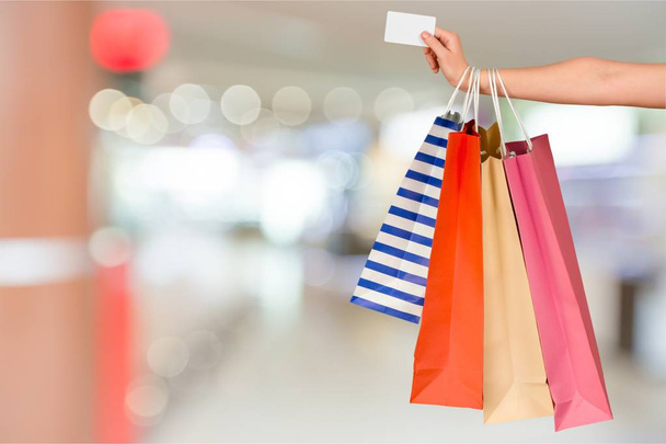 Young woman with shopping bags and credit card  - Photo, image