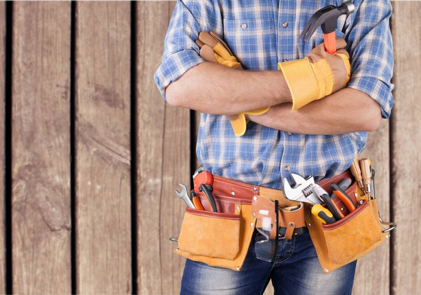 Young man worker with tool belt  - Zdjęcie, obraz
