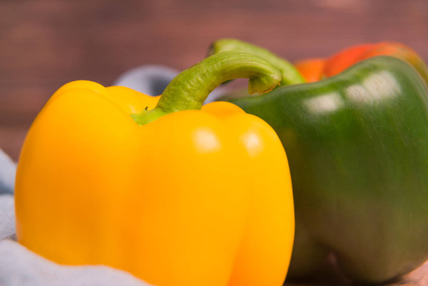 closeup yellow and green bell pepper on the wooden backgrounds with copy space - Photo, Image