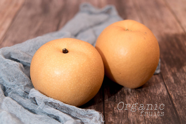 fresh organic pear fruits on the wooden backgrounds with copy space - Photo, Image