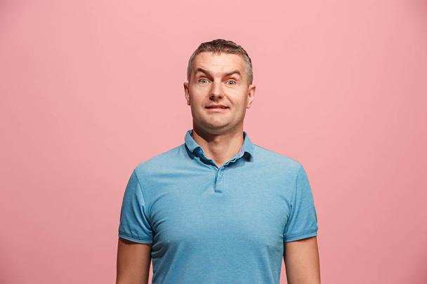 The young attractive man looking suprised isolated on pink - Photo, image