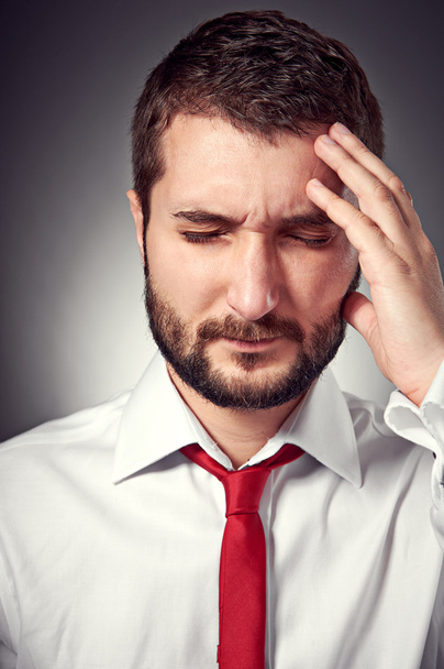 man with headache over grey background - Фото, изображение
