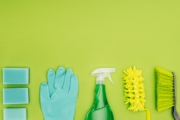 top view of rubber glove and spray bottle isolated on light green - Zdjęcie, obraz