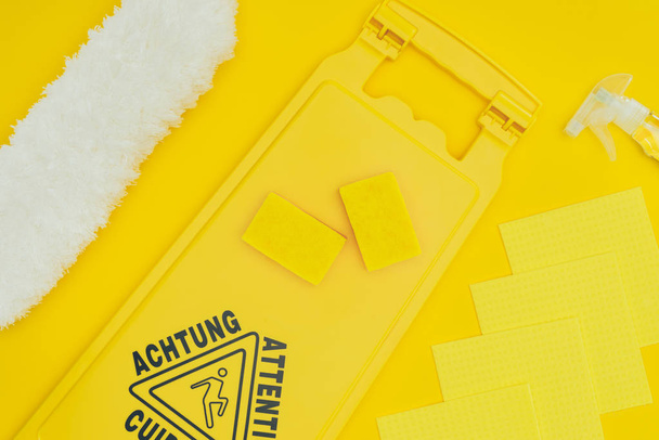 top view of wet floor sign and washing sponges isolated on yellow - Photo, Image