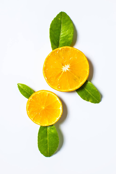 Orange with slice and leaf isolated on the white background - Фото, изображение