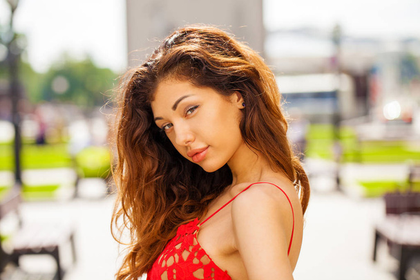Beautiful brunette woman in sexy red dress - Фото, зображення