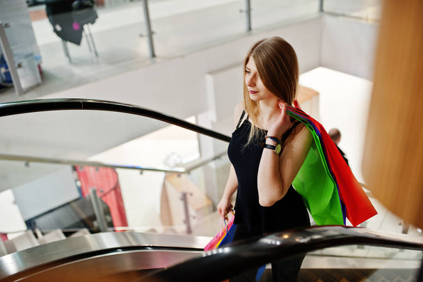 Girl with shopping bags in the mall at the escalator. - Foto, Bild