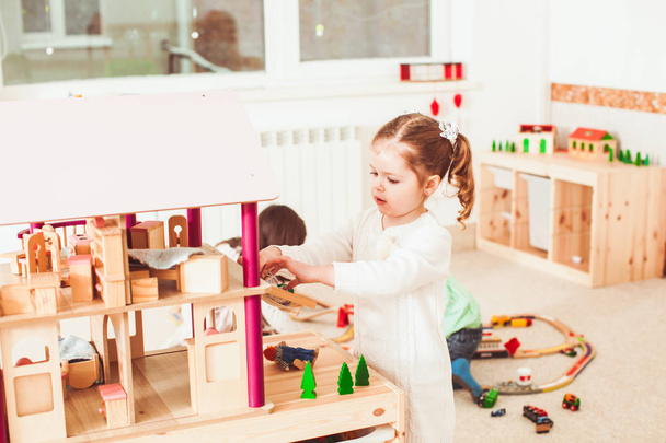 Girl playing with a dollhouse - Photo, Image