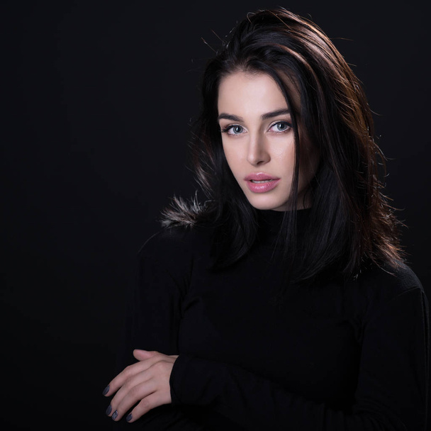 Beautiful girl posing over black background. Young pretty woman  - Valokuva, kuva