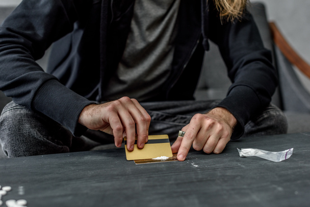 cropped shot of addicted man preparing to take cocaine - Photo, Image