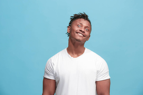 The squint eyed afro-american man with weird expression isolated on blue - Foto, imagen