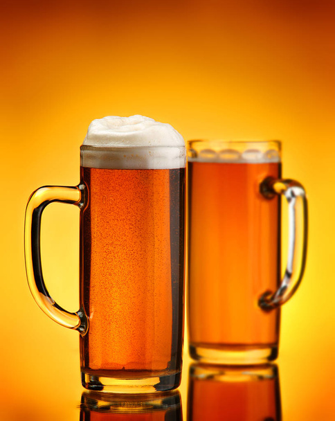 Beer beverage on yellow background - Фото, изображение