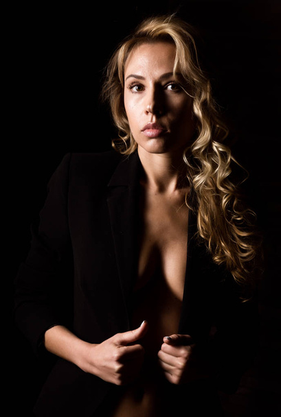 silhouette of a sexy woman on a black background. Shadows on beautiful body of sexy elegant woman. - Фото, зображення