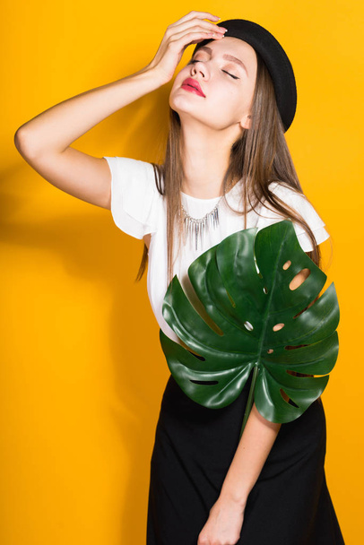  girl model in hat posing , holding a green  - Zdjęcie, obraz