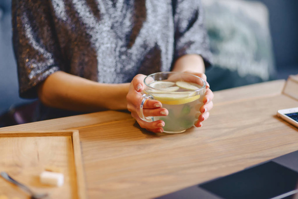hot tea with lemon in delicate women's hands - Photo, Image