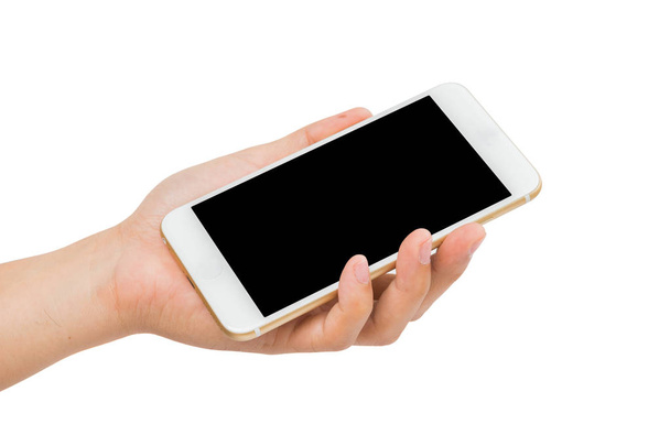 Mano sosteniendo teléfono inteligente de oro sobre fondo blanco
 - Foto, imagen