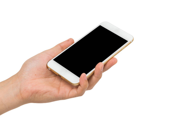 Mano sosteniendo teléfono inteligente de oro sobre fondo blanco
 - Foto, Imagen