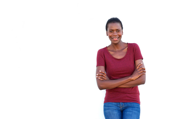 Ritratto di giovane donna nera sorridente in piedi con le braccia incrociate su sfondo bianco
 - Foto, immagini