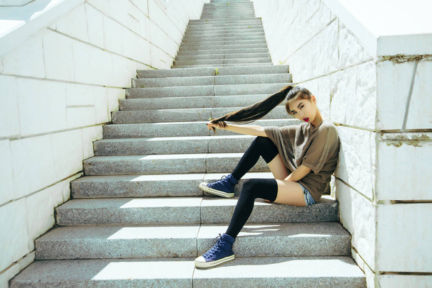   Asian  girl with long black hair sitting  on the stairs - Fotó, kép