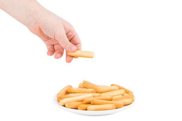 hand holding plate of crispy bread sticks on white background. B - Photo, Image