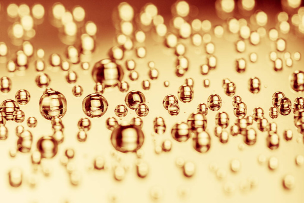 water gold, golden, drops on black background. Macro extreme. - Фото, изображение