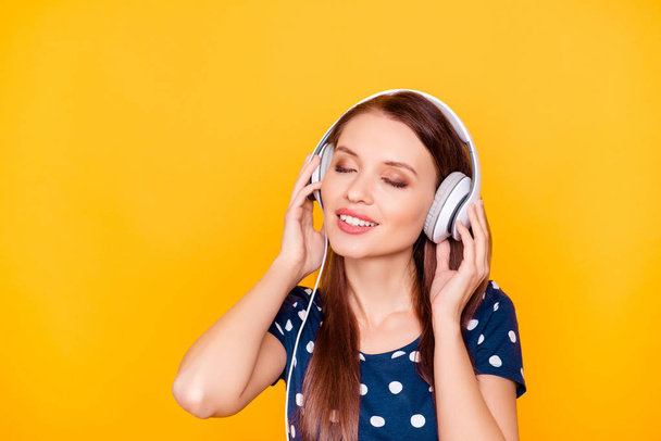 Portrait of pretty, charming, nice woman with headphones on her  - Фото, изображение