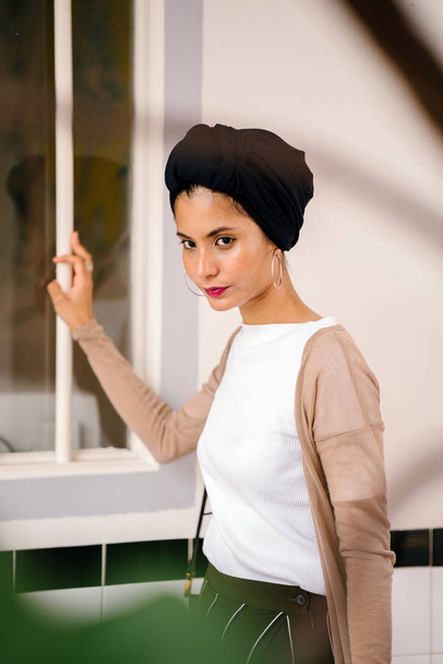 Portrait of a young Muslim woman (Islam) wearing a turban (headscarf, hijab). She is elegant, attractive and professionally dressed. - Fotografie, Obrázek