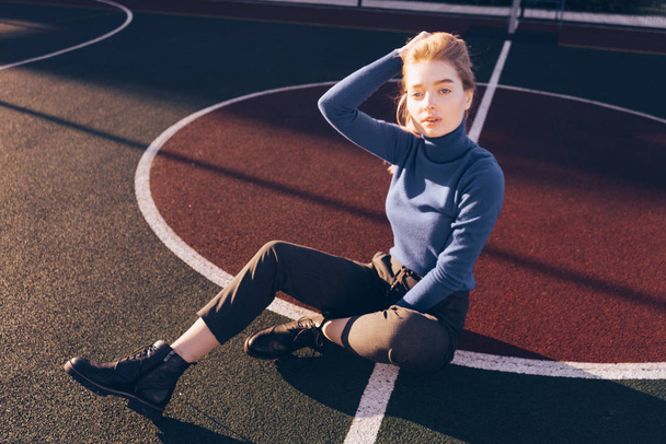girl blonde posing in the sun, on a sports field - Photo, Image
