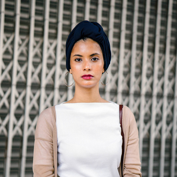 Portrait of a young Muslim woman (Islam) wearing a turban (headscarf, hijab). She is elegant, attractive and professionally dressed. - Fotoğraf, Görsel