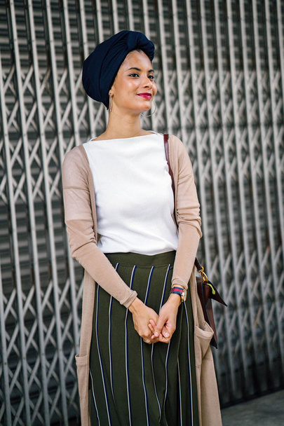 Portrait of a young Muslim woman (Islam) wearing a turban (headscarf, hijab). She is elegant, attractive and professionally dressed. - Photo, image
