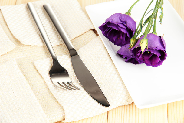 Tableware with flower on bright napkin close-up - Foto, imagen