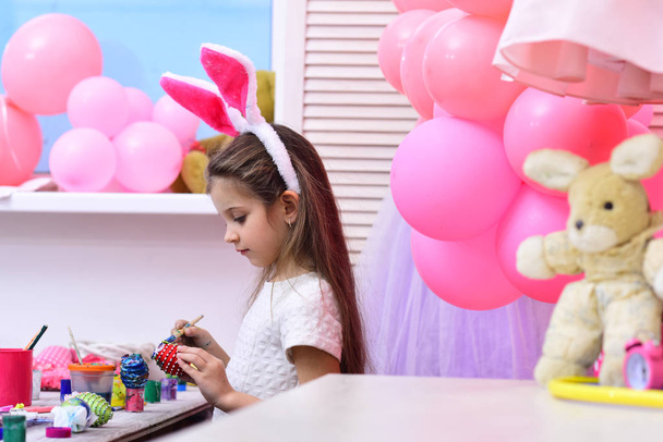 Daughter paint handmade egg at party balloons. - 写真・画像