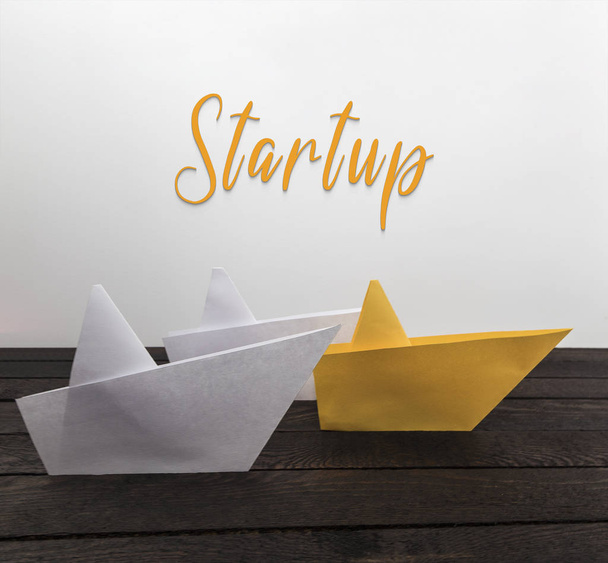Startup concept. Paper boats on wood with inscription: Comfort zone. - Photo, Image